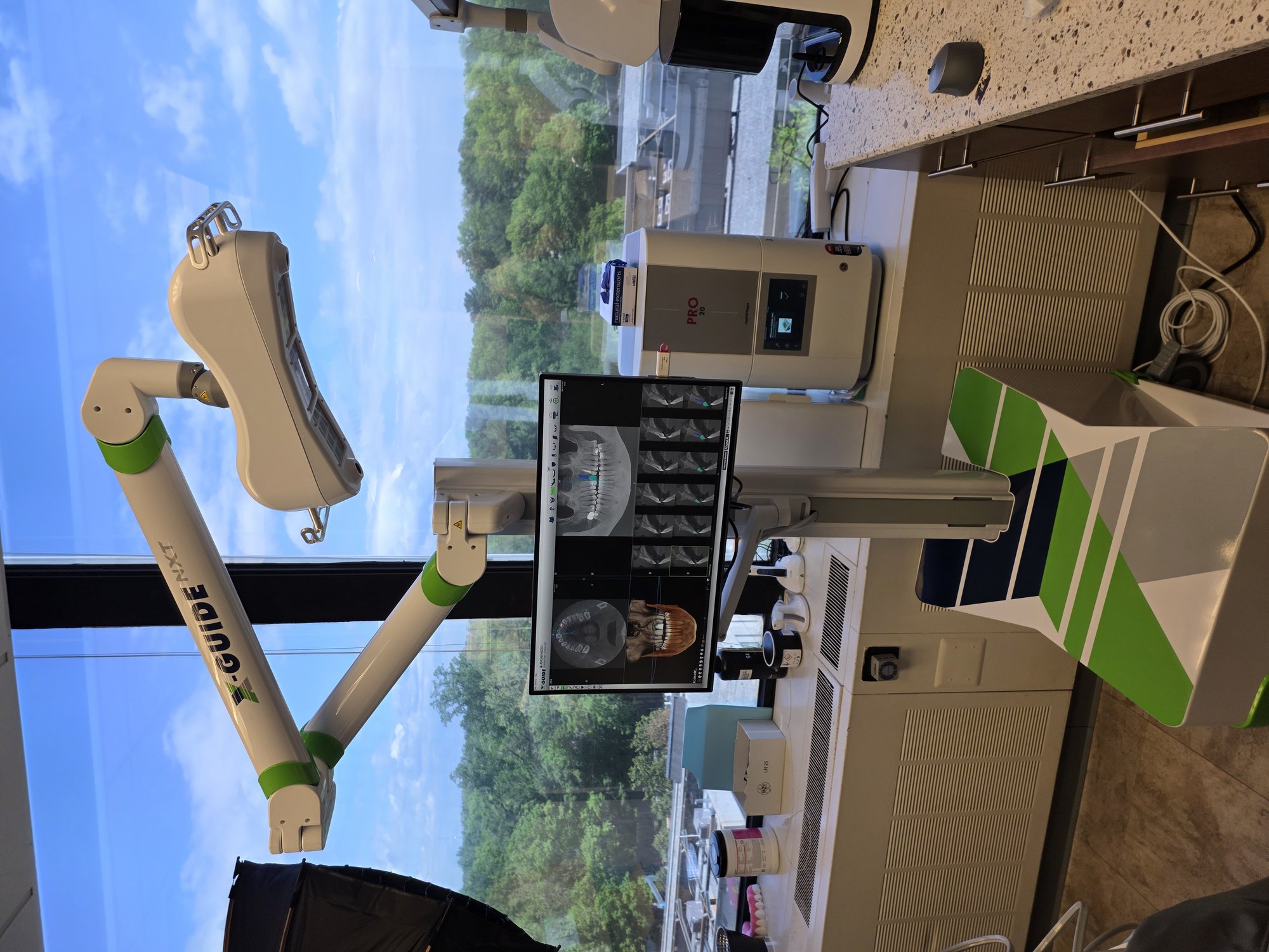 X-Guide NXT dynamic navigation system with CBCT scan displayed on monitor — used during guided implant surgery at Radiant Dental Care